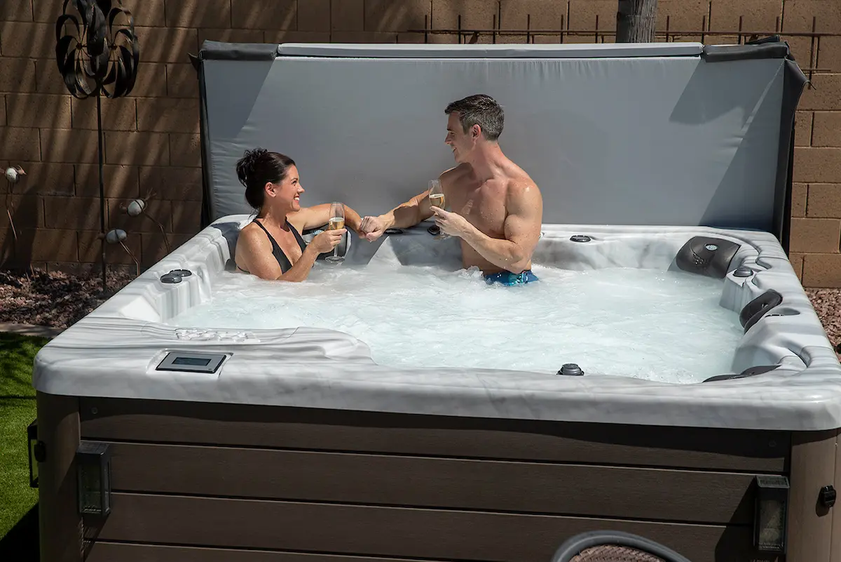 A couple relaxing in a spa after learning how much does a hot tub cost in Texas