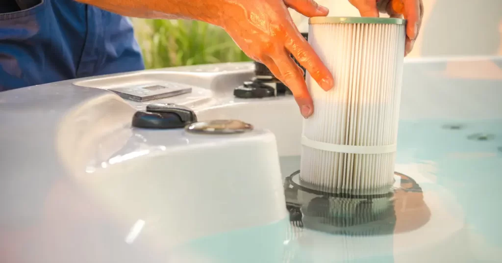 Person cleaning a hot tub filter after learning how to clean a hot tub.