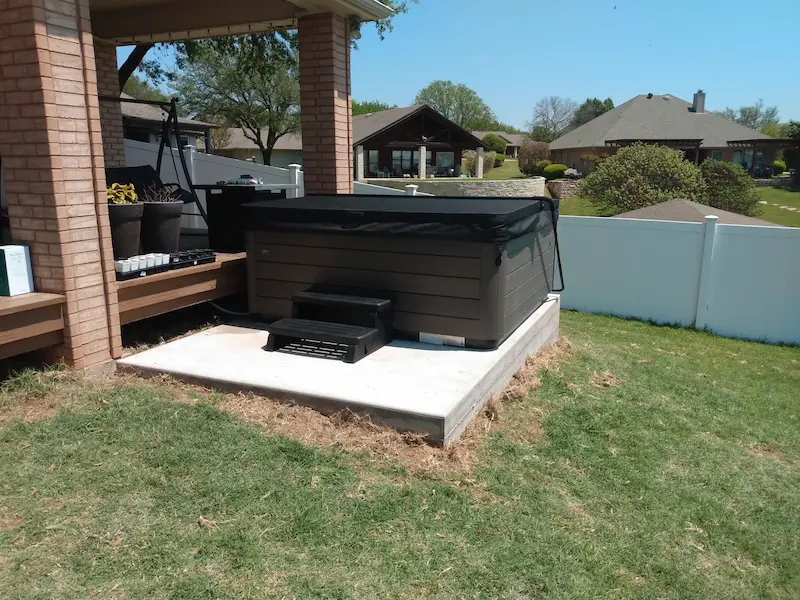 Vita hot tub installed on a raised concrete slab