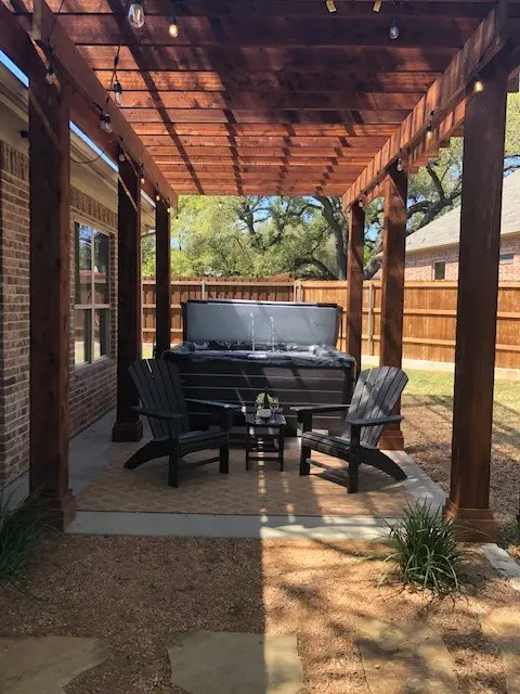 Vita hot tub installed under a pergola