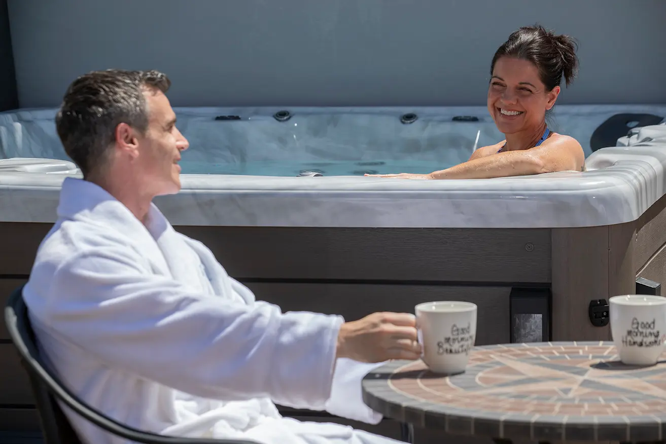 Couple enjoying their new spa after buying a hot tub in Aledo from JR Spas.